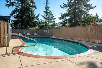 a resort style pool with a fence around it